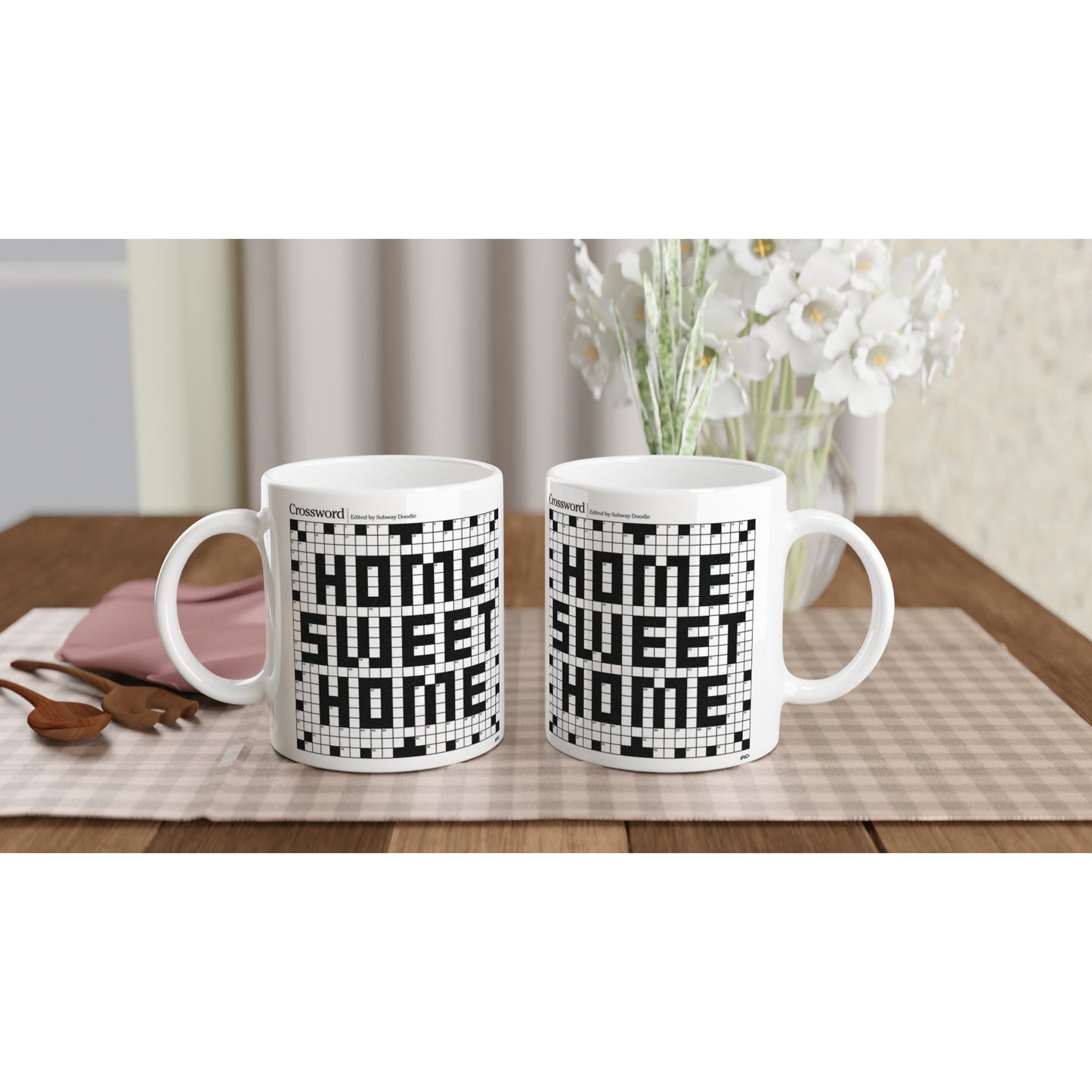 A pair of Home Sweet Home crossword puzzle mugs sit on a kitchen table.