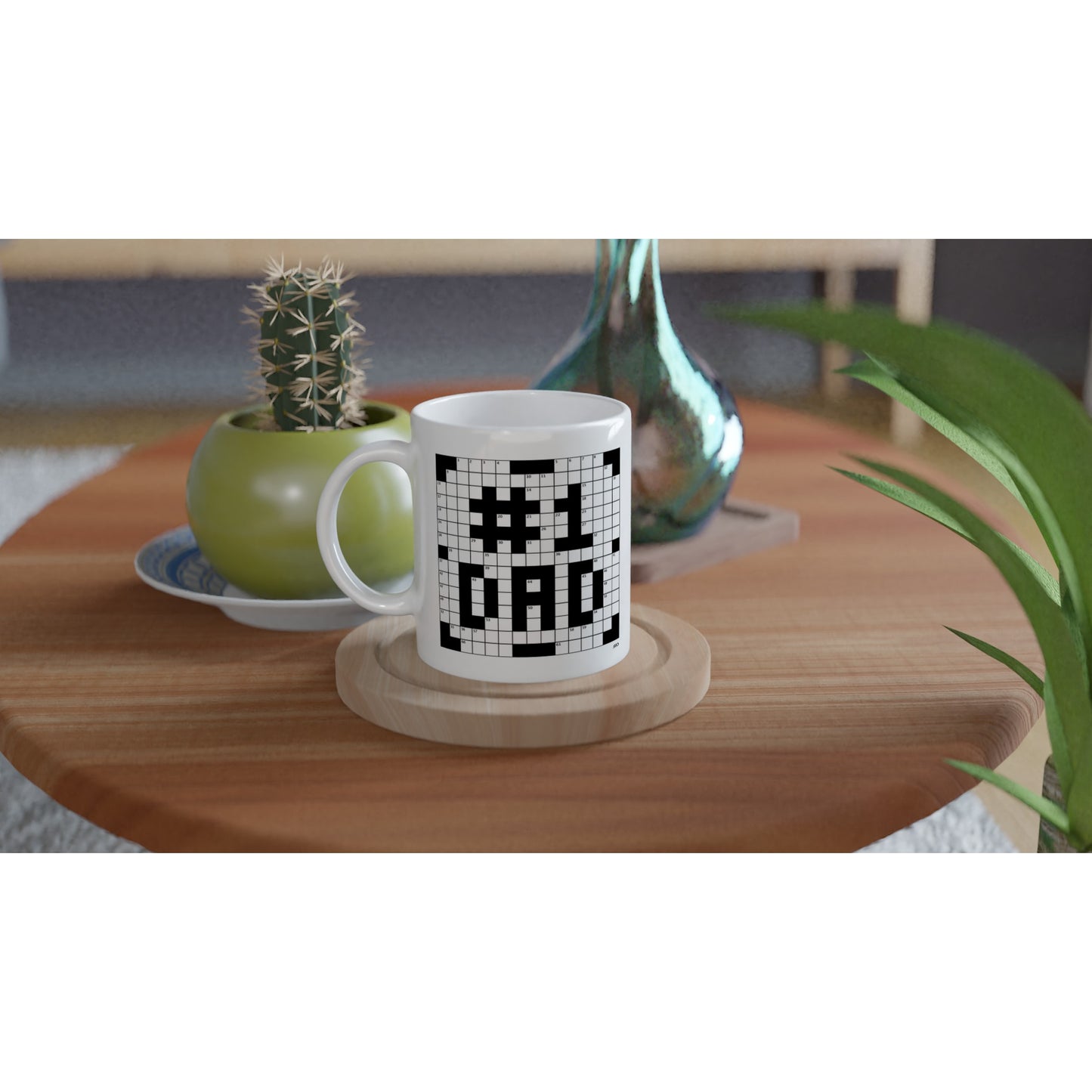 A white coffee or tea mug with a crossword themed graphic that reads #1 DAD on an end table next to a small cactus.