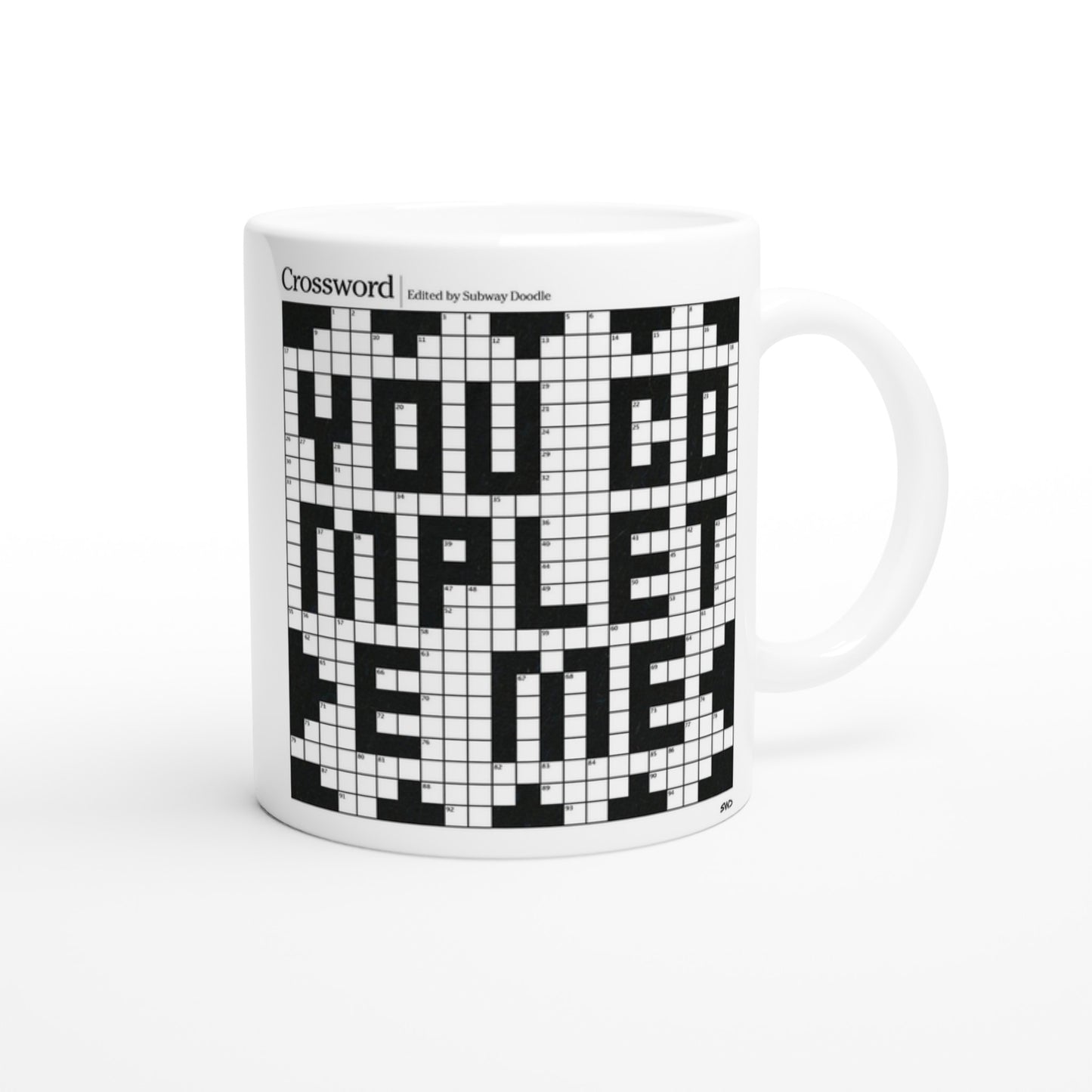 The reverse side of a white mug with a crossword puzzle graphic that reads YOU COMPLETE ME.